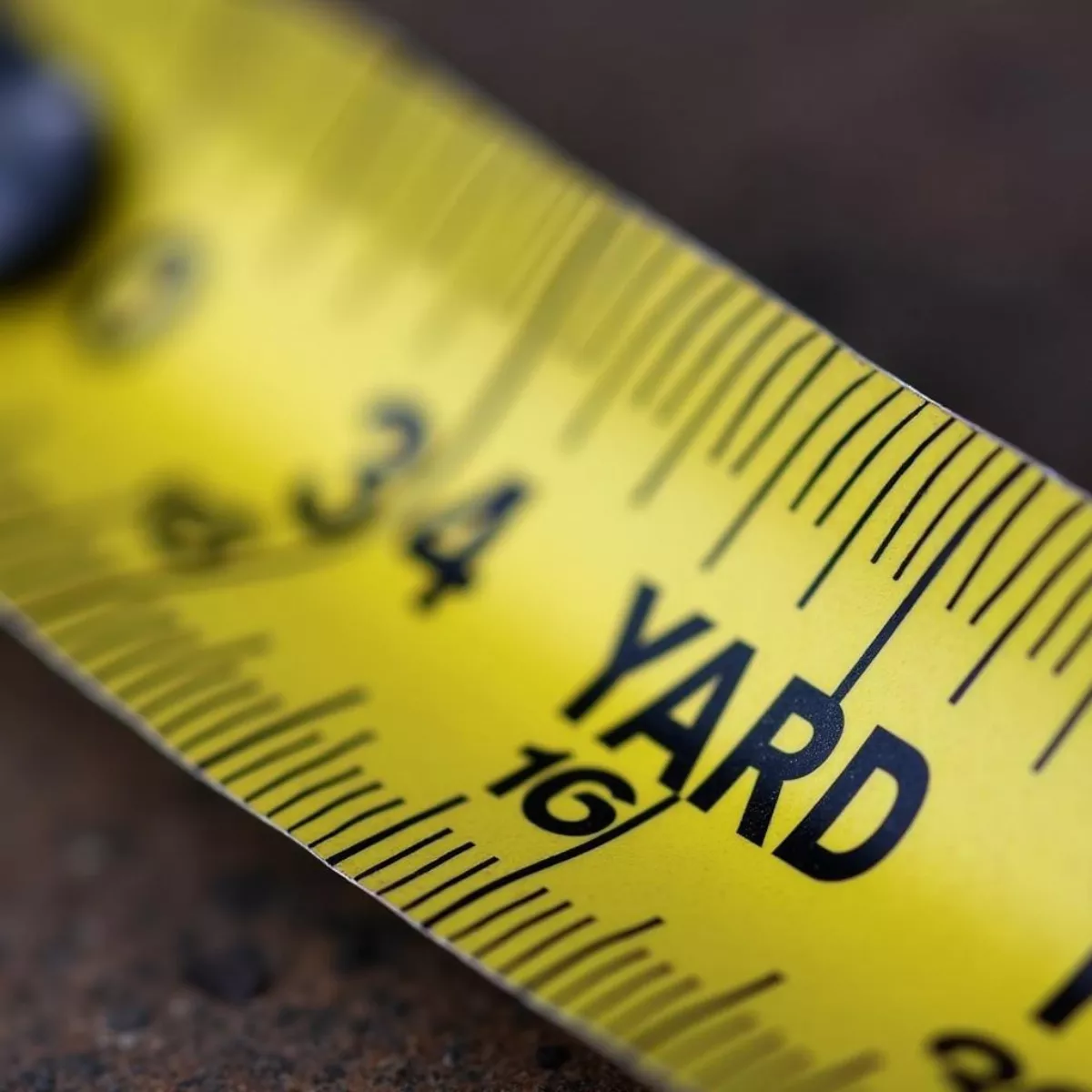 Close-Up Of Measuring Tape With Yard Markings