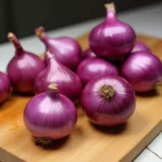Red onions on a chopping board